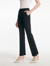 A woman wears black pants in modal fabric.